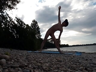 Slender nudist Jon Arteen basks in the sun on a naturist beach, doing yoga nude. His flexible poses and tantalizing twink allure make for a captivating naked yoga video.