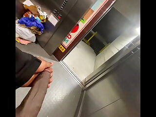 Public thrills ensued as a BBC moment unfolded in an elevator. The solo amateur, caught mid-stroke, teased with his massive black cock, nearly exposing himself. A tantalizing voyeuristic display of self-pleasure.